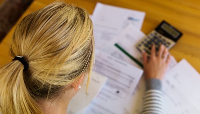 Woman Using Calculator