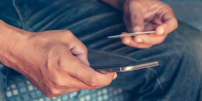 Man holding credit card and phone