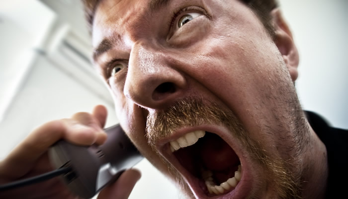Man Screaming into Phone