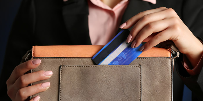 Woman Pulling Credit Card Out Of Wallet